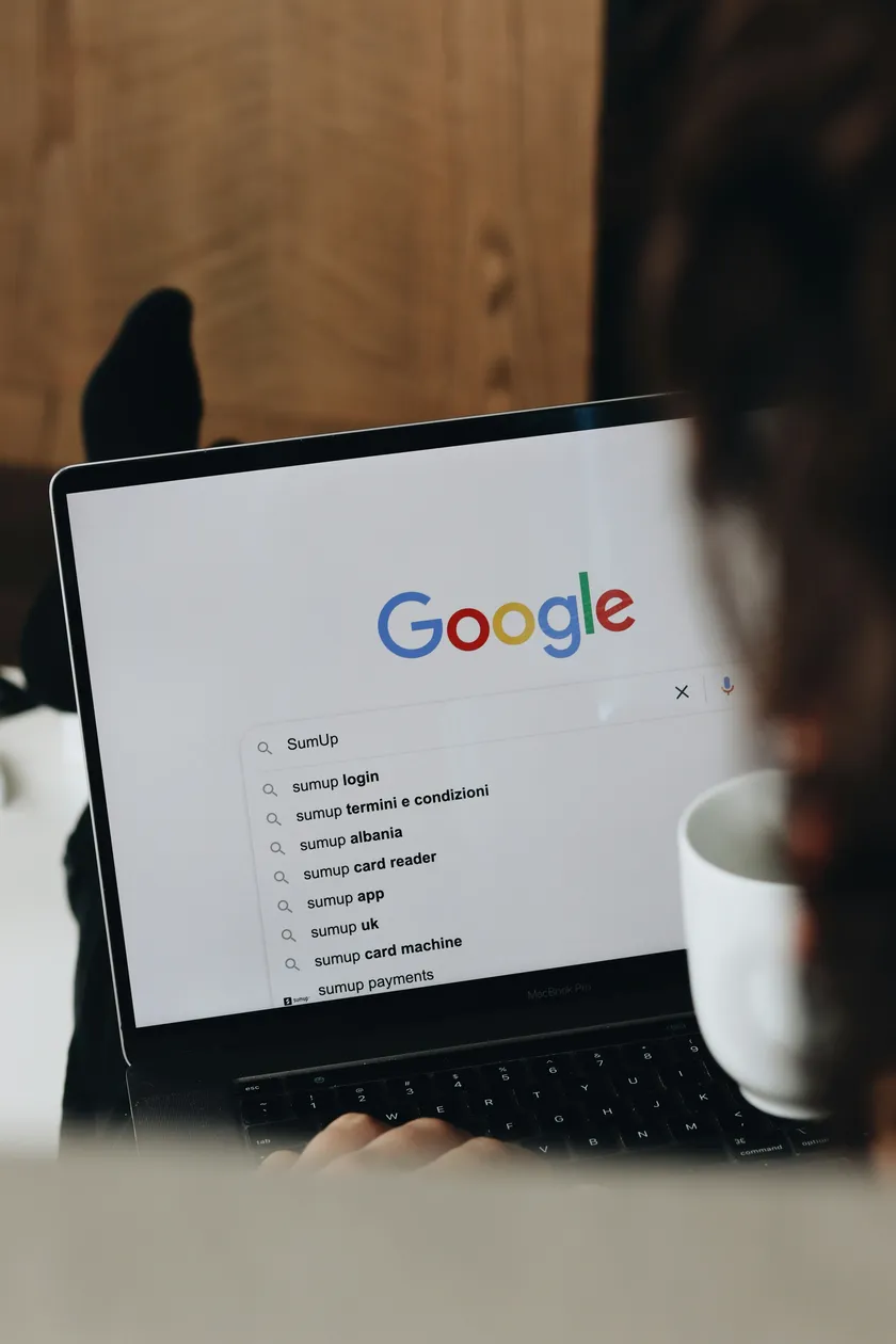 User typing in Google search with business suggestions appearing, symbolizing improved SEO visibility