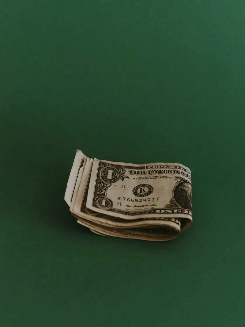 Small stack of dollar bills symbolizing affordable, tailored website pricing